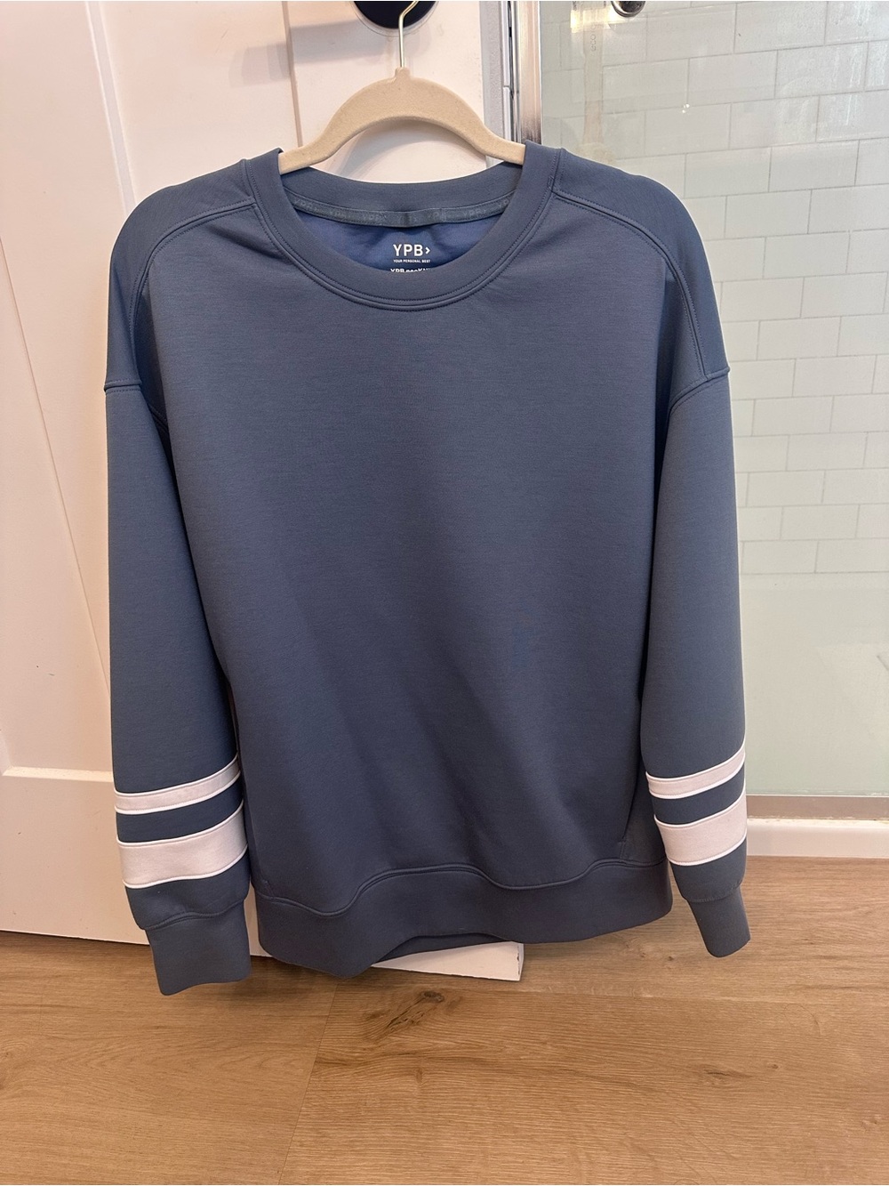 Abercrombie Women’s Crewneck with white stripped detail on sleeves.